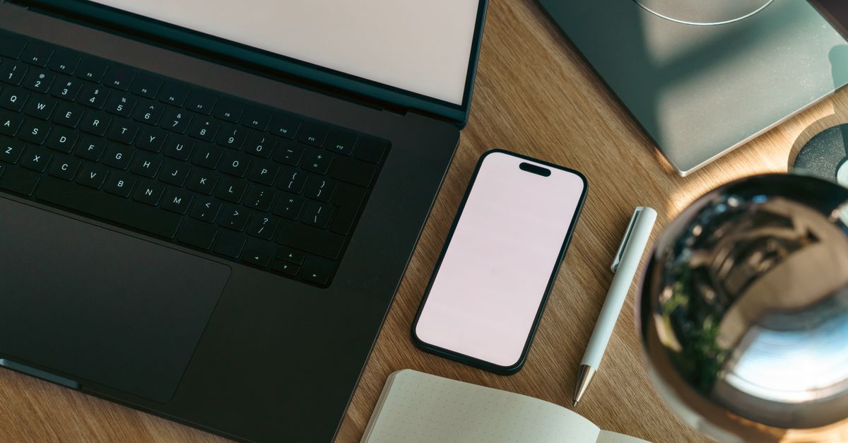 Modern workspace with laptop and smartphone on a clean desk