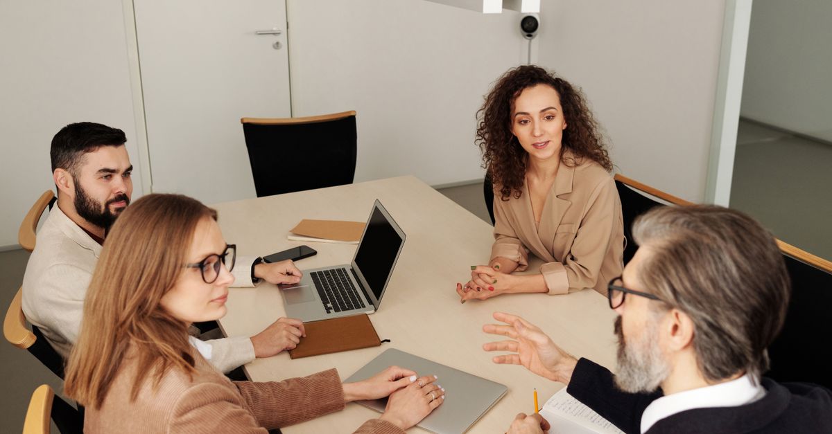 Business team around a table in a meeting discussing strategy